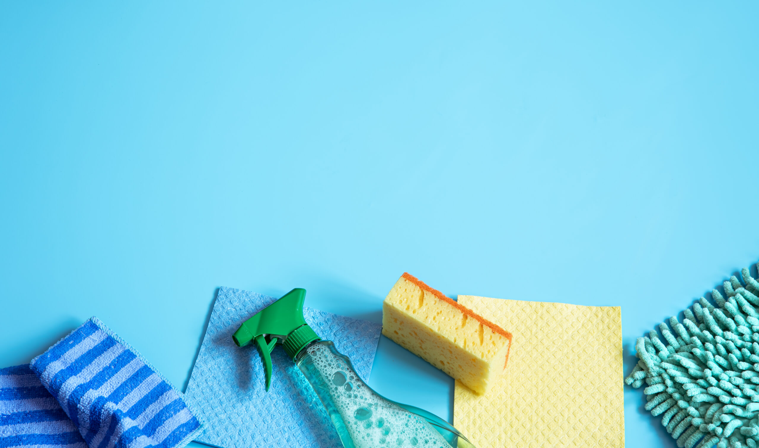 Colorful composition with sponges, rags, gloves and detergent for general cleaning. Cleaning service concept.
